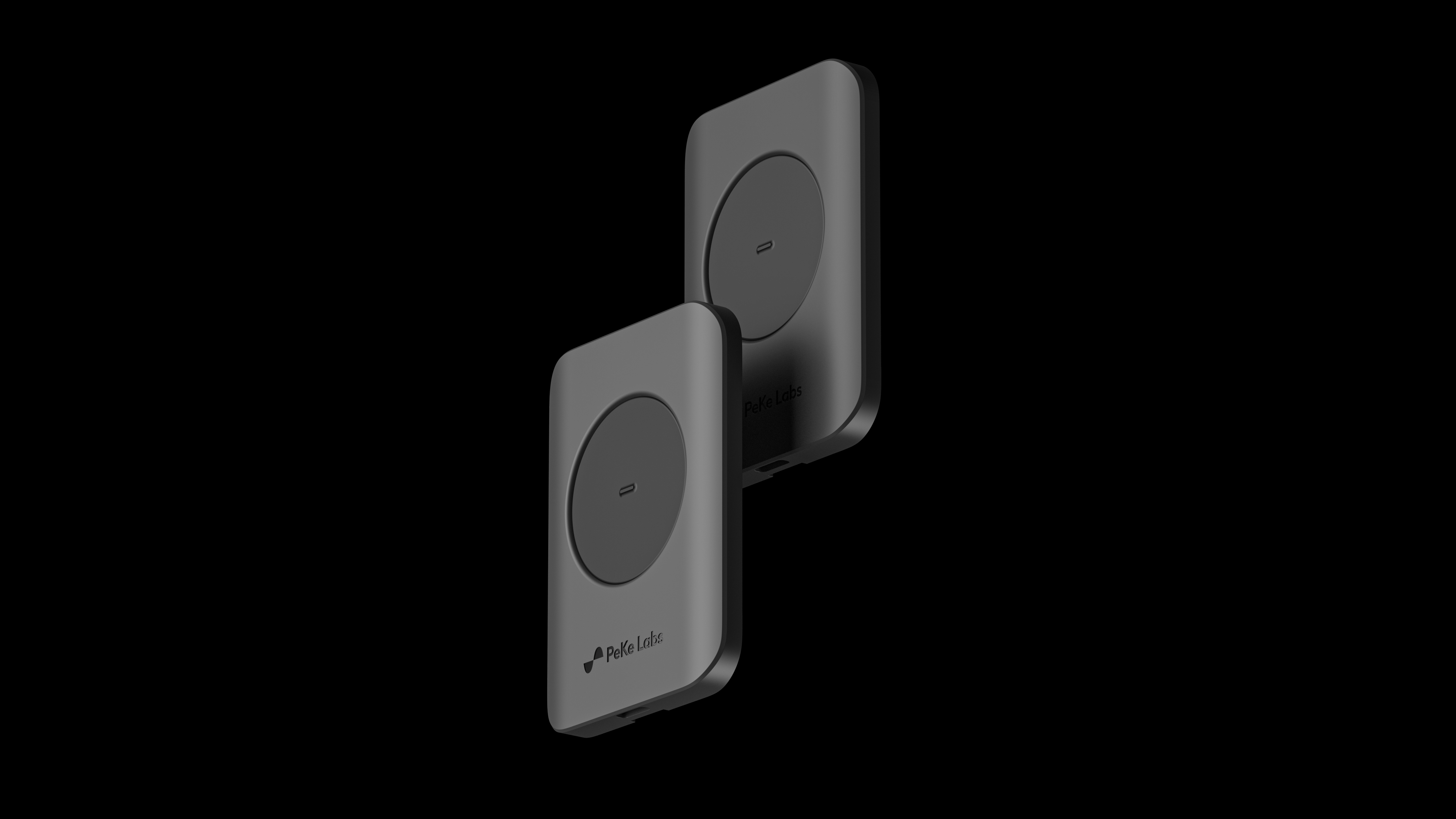 Two GID reference controllers - small dark devices, each with a circular touch pad - against black.